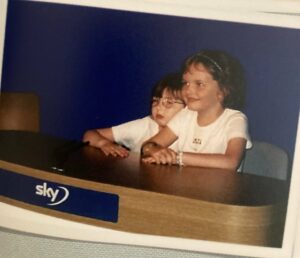 a young helena horton with her twin sister at a table labelled sky news