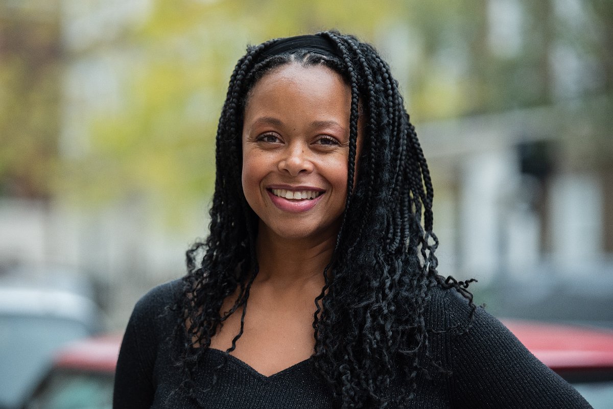 Greta smiles looking to camera.