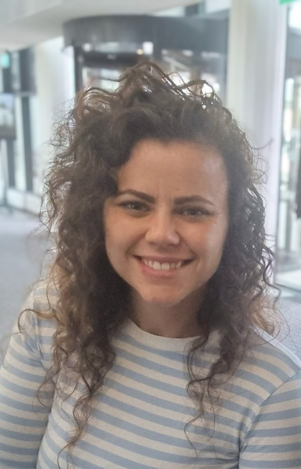 Alice Linn looks to camera wearing a stripey top